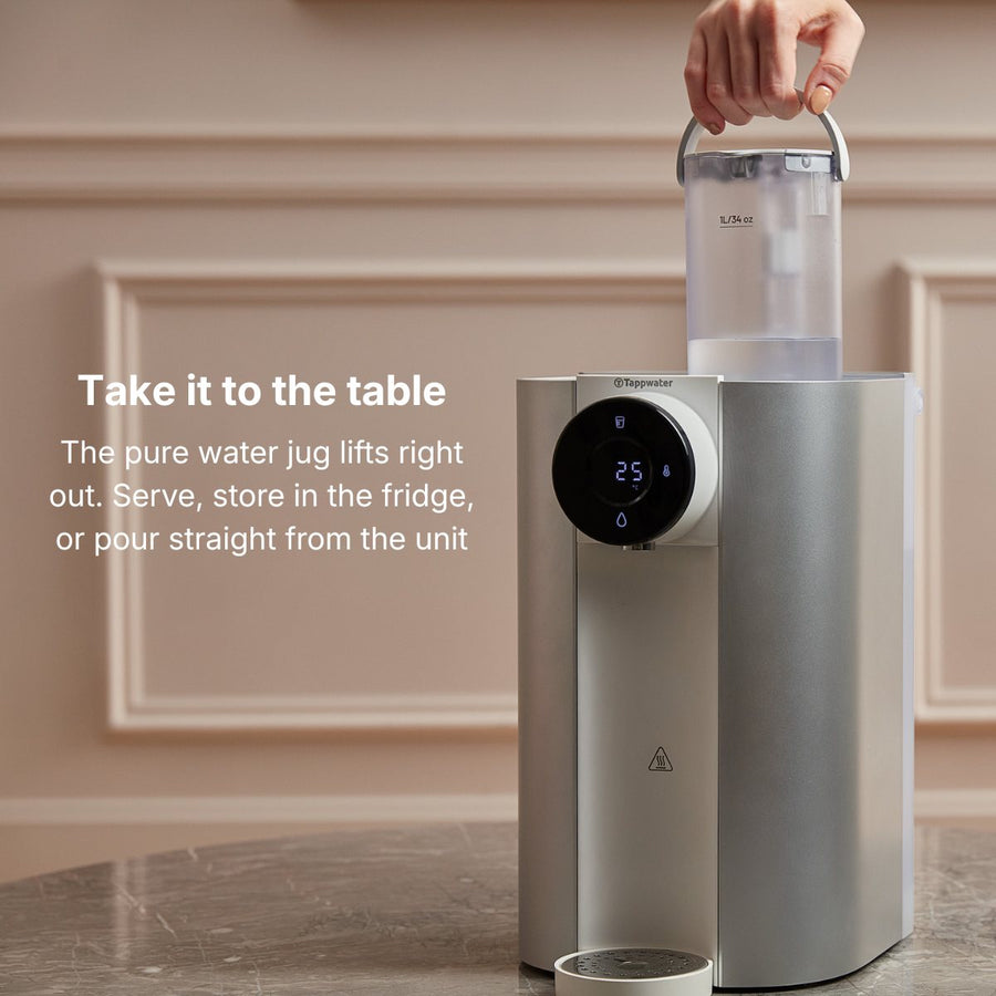 Hand lifting the 1 litre pure water jug out of the reverse osmosis filter to carry to the table or store in the fridge